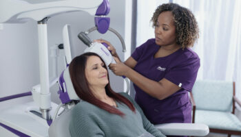 A woman receiving TMS treatment