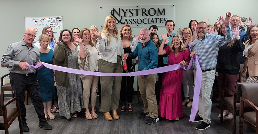 People about to cut a ribbon at the Eden Prairie TMS ribbon cutting